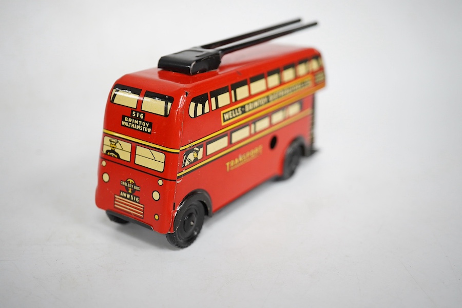 A boxed Wells Brimtoy tinplate clockwork trolley bus loosely in London Transport livery, together with three keys. Condition fair to good, clockwork motor appears to work correctly although has lost grip on the driving a